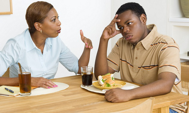 Mother scolding son during lunch